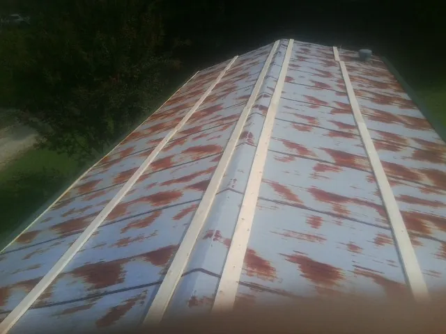Rusted metal roof panels with new wood purlins before replacement — Storm Damage Roof Repair in Dupont by Roofing Brothers